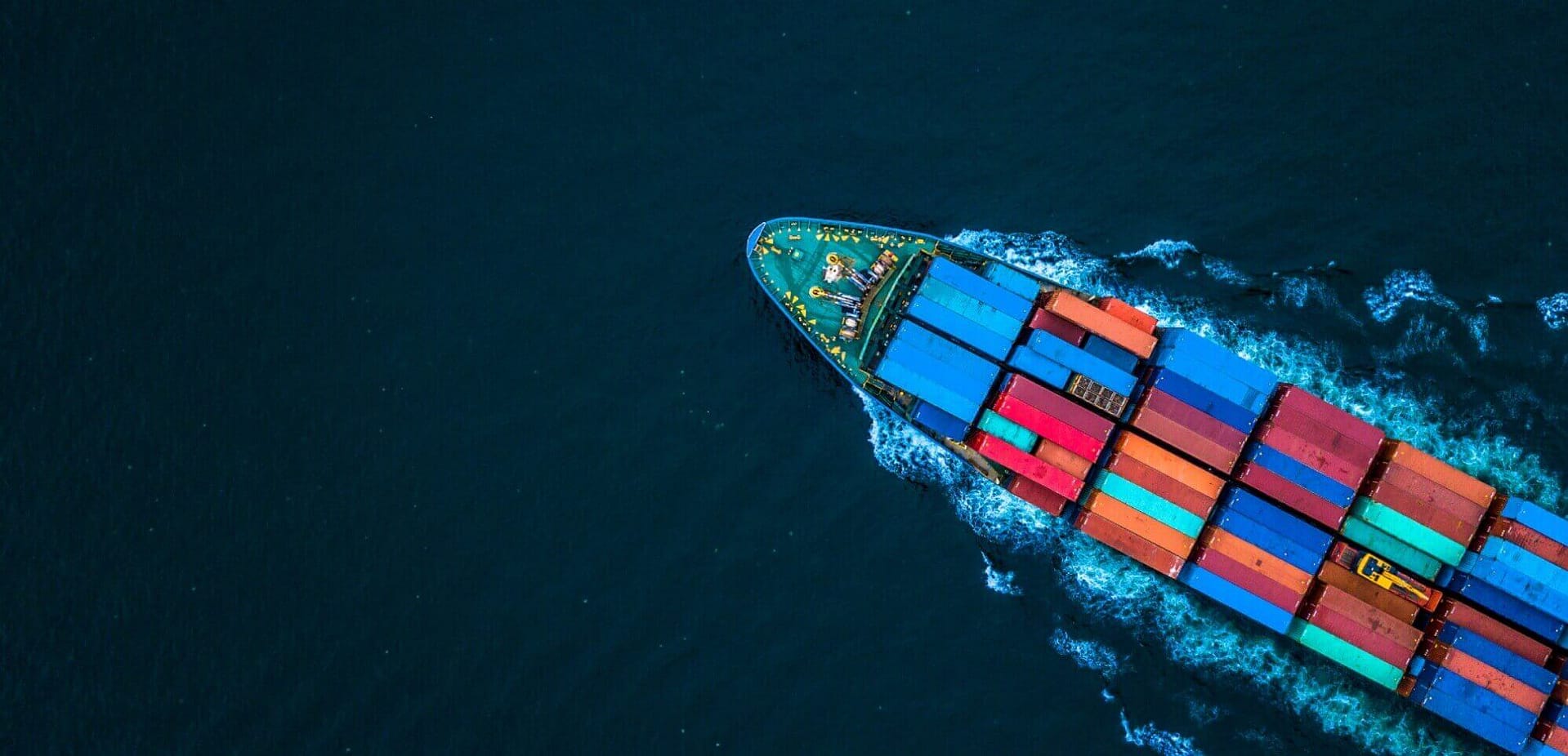 A colorful container ship sailing through the ocean.