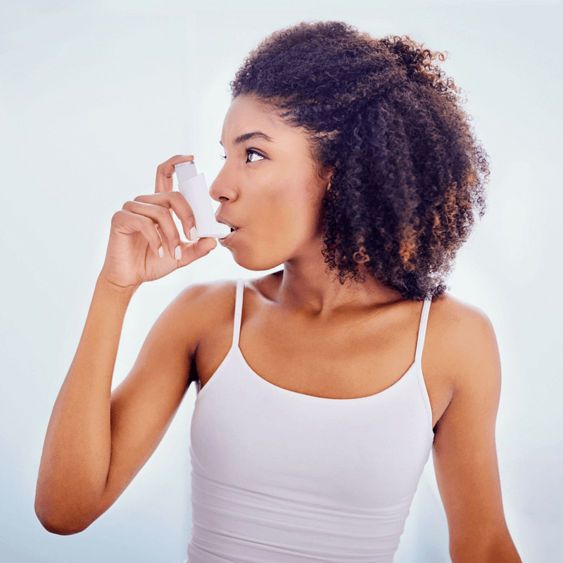 Woman using inhaler