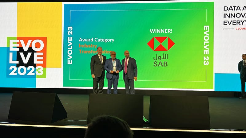 Hari Baskar accepts Data Impact Award, at Evolve 2023, sponsored by Cloudera.